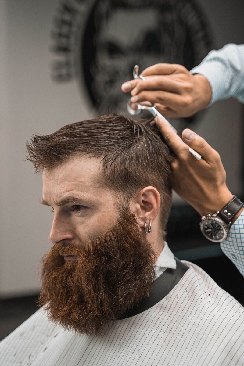 Scissor-over-comb trim on top with a full beard
